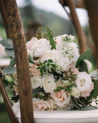 Bridal bouquet, bride’s bouquet with flowers done by Sweet Elegance Floral design florist in Kelowna, BC. Hand tied rustic bouquet featuring roses, ranunculus, spray roses, lisianthus and eucalyptus in pink, creams and white.