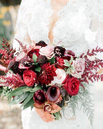 Bridal bouquet, bride’s bouquet with flowers done by Sweet Elegance Floral design florist in Kelowna, BC. Dark, moody, Hollywood glam bouquet of roses, callas, astilbe, roses, dahlias in red, burgundy, purple and cream.