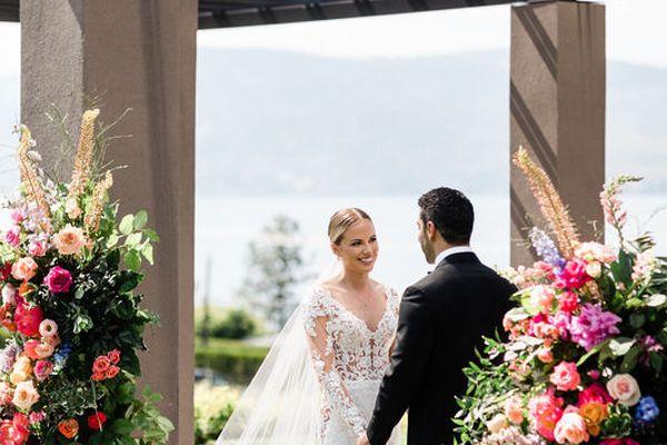 Okanagan Wedding Ceremony Bright Floral Pillars Bride And Groom